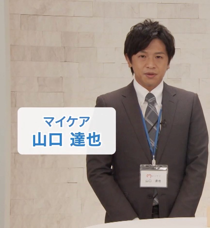 スーツ姿のマイケア 山口達也さん