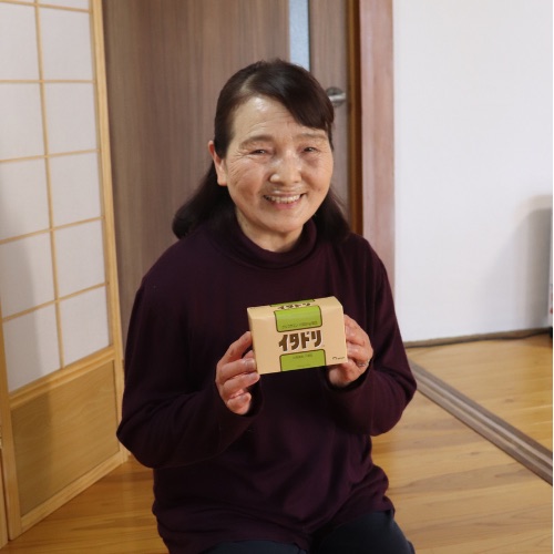 イタドリのパッケージを持つ60代女性の愛用者
